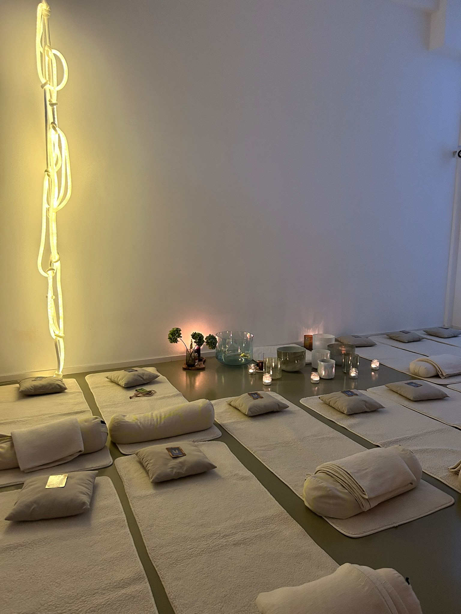 Yogamatten, Kissen und Kerzen in warmer Abendstimmung